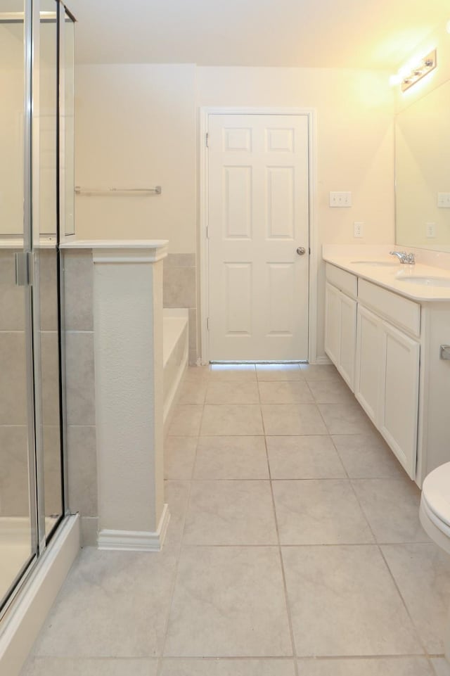 full bathroom featuring tile patterned flooring, a shower stall, vanity, and a bath