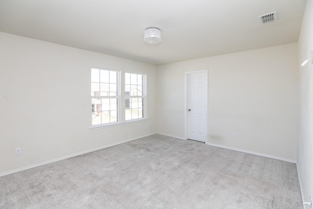 carpeted spare room featuring baseboards