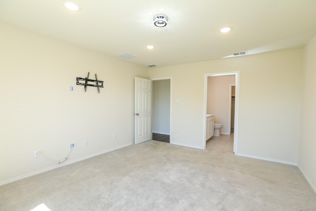 unfurnished room with light carpet, recessed lighting, and baseboards