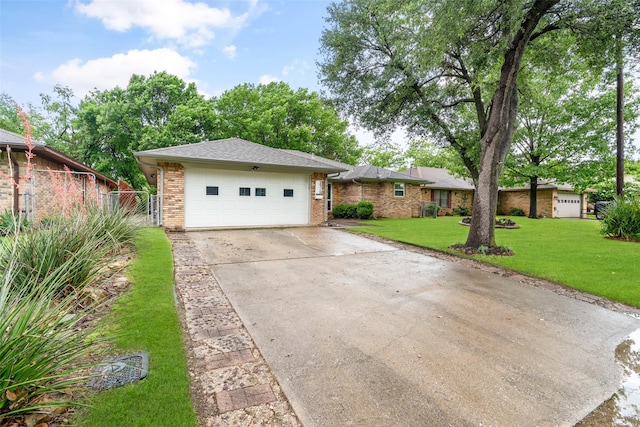single story home with brick siding, a garage, and concrete driveway