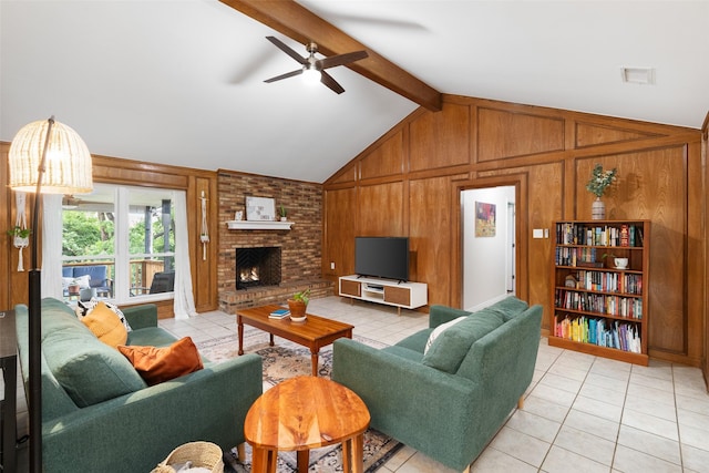 living area with a ceiling fan, light tile patterned flooring, wooden walls, and a brick fireplace