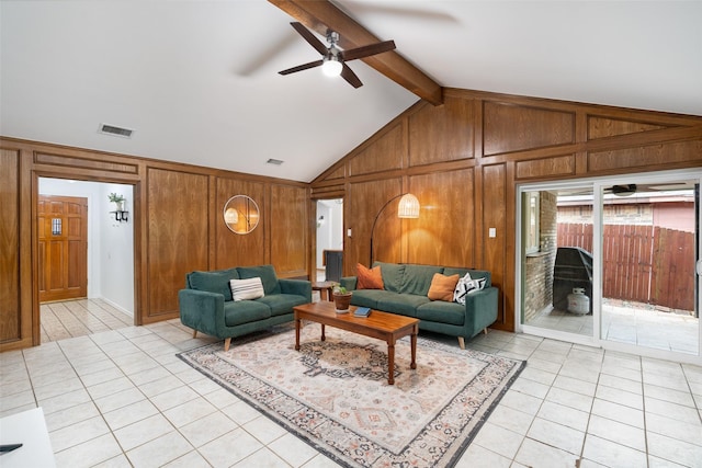 living room featuring light tile patterned floors, wooden walls, and a ceiling fan