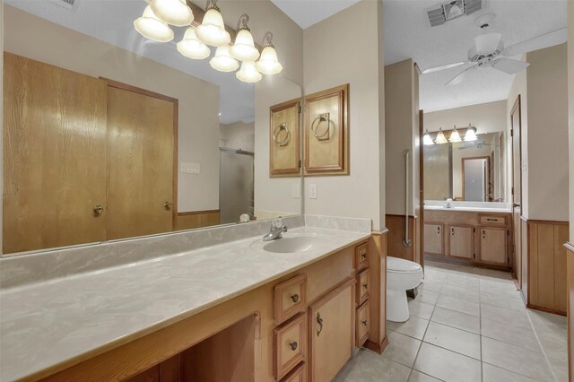 23010 County Road 3313, Chandler, TX 75758 - bathroom with tile patterned floors, toilet, vanity, a stall shower, and ceiling fan
