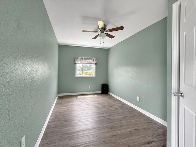 23010 County Road 3313, Chandler, TX 75758 - empty room featuring a textured wall, ceiling fan, wood finished floors, and baseboards
