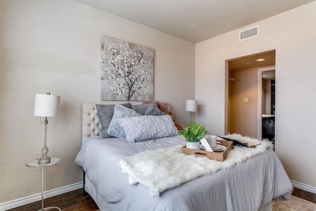 bedroom with wood finished floors and baseboards