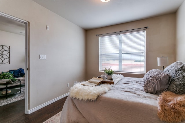 bedroom featuring dark wood-type flooring and baseboards