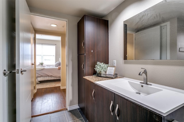 bathroom with vanity and baseboards