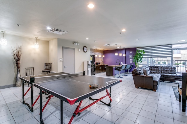 rec room featuring light tile patterned floors, recessed lighting, and a chandelier