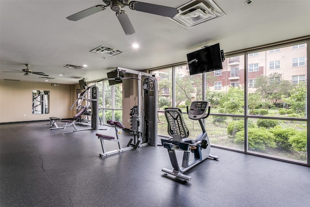 exercise room with a ceiling fan, expansive windows, and recessed lighting