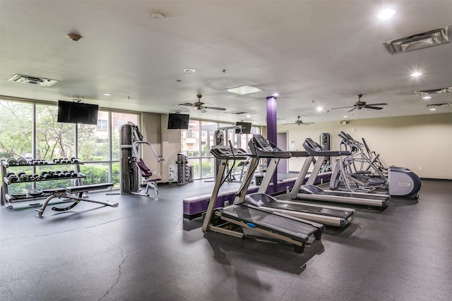 exercise room featuring ceiling fan, a wall of windows, and recessed lighting