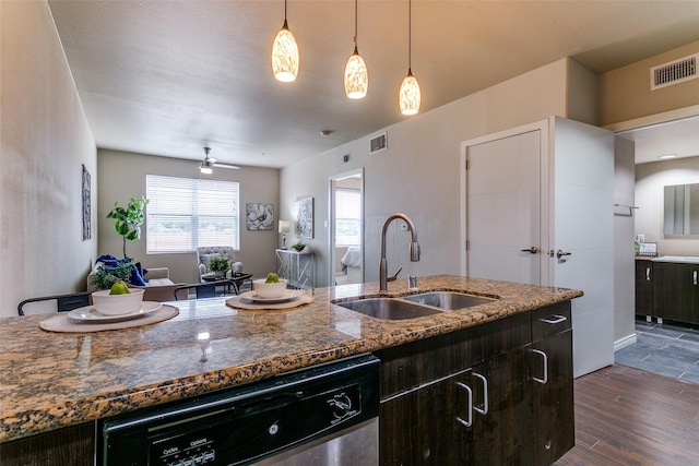 kitchen with dishwasher, a sink, dark wood finished floors, open floor plan, and ceiling fan