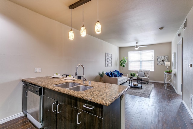 kitchen with a sink, dishwasher, dark brown cabinets, dark wood-type flooring, and ceiling fan