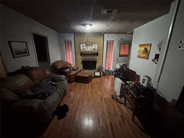 living area featuring wood finished floors and a fireplace