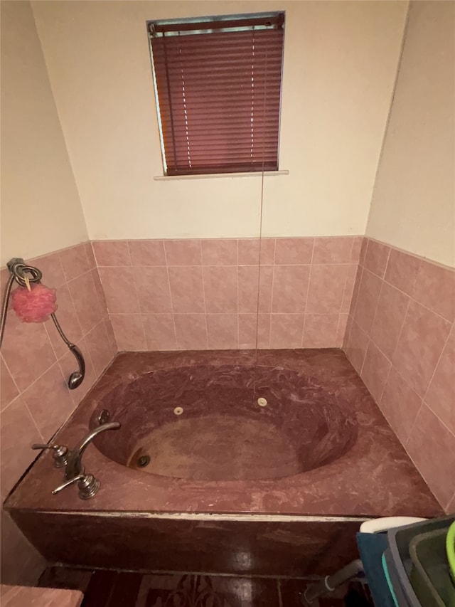 full bath featuring a tub with jets