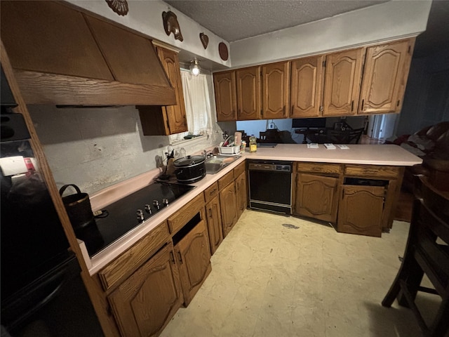 kitchen featuring black appliances, custom exhaust hood, light countertops, a textured ceiling, and brown cabinetry