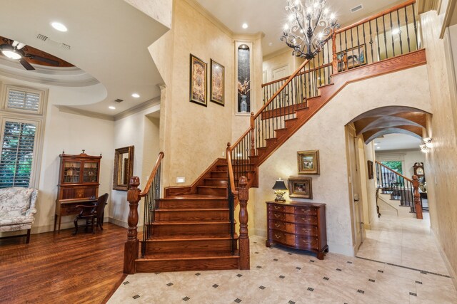 5957 Aberdeen Pl, Frisco, TX 75034 - stairs with a high ceiling, ornamental molding, arched walkways, a ceiling fan, and baseboards