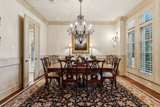 5957 Aberdeen Pl, Frisco, TX 75034 - dining space with a chandelier, wood finished floors, crown molding, and wainscoting