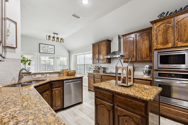 9529 Cholla Cactus Trl, Fort Worth, TX 76177 - kitchen with stainless steel appliances, a sink, wall chimney range hood, decorative backsplash, and lofted ceiling