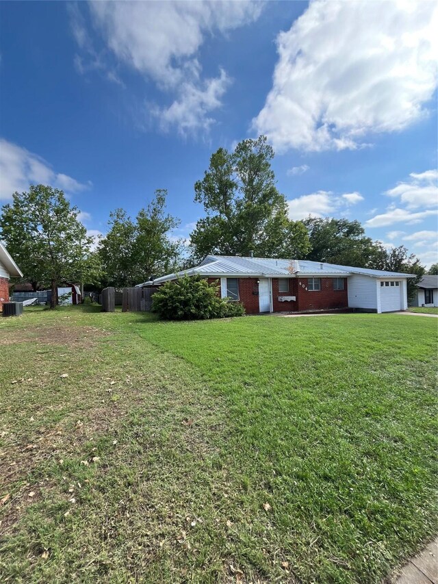 604 E 5th St, Weatherford, TX 76086 - kitchen featuring white appliances, light countertops, light tile patterned floors, a warming drawer, and brown cabinets