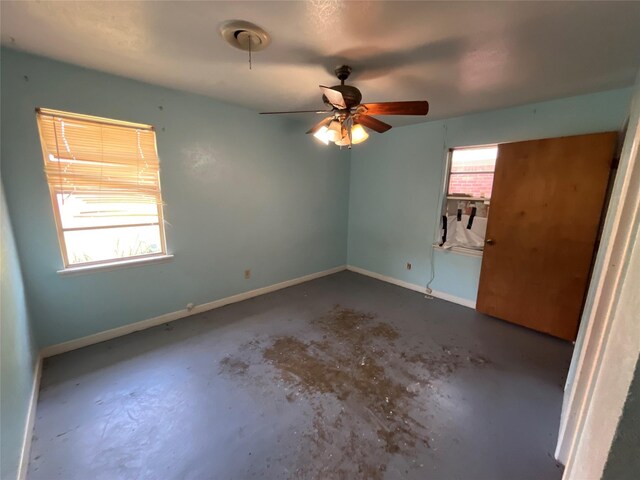 604 E 5th St, Weatherford, TX 76086 - bedroom featuring concrete floors, cooling unit, and a ceiling fan