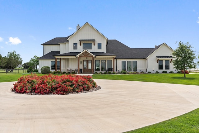 109 Old Decatur Rd, Decatur, TX 76234 - view of front of property with french doors, a chimney, a front yard, curved driveway, and board and batten siding
