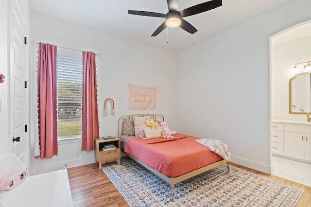 109 Old Decatur Rd, Decatur, TX 76234 - bedroom with light wood finished floors, baseboards, ensuite bathroom, and ceiling fan