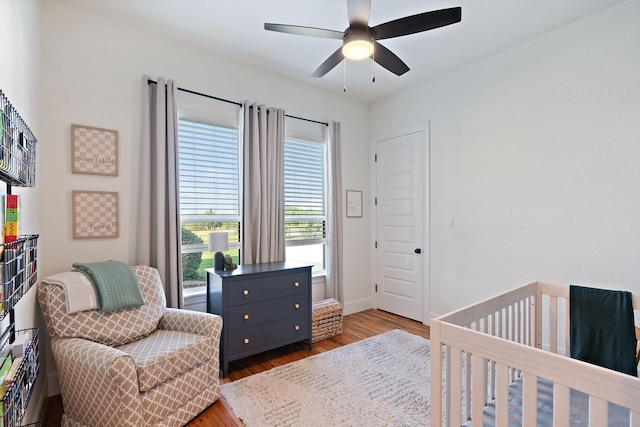 109 Old Decatur Rd, Decatur, TX 76234 - bedroom with wood finished floors, a ceiling fan, baseboards, and a crib