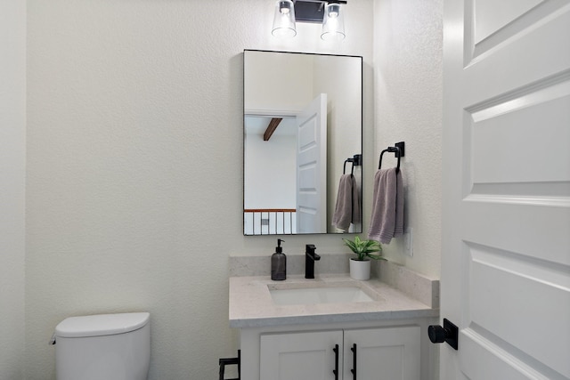 109 Old Decatur Rd, Decatur, TX 76234 - half bathroom featuring toilet, vanity, and a textured wall