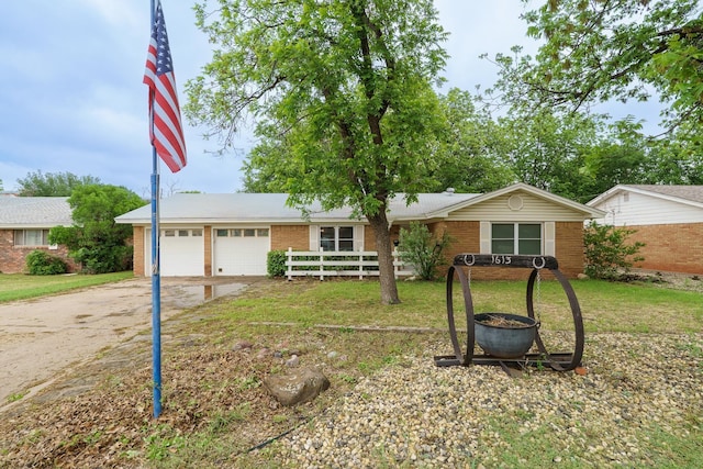 single story home with concrete driveway, an attached garage, and brick siding
