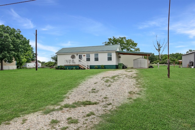 7265 Guadalupe Trl, Weatherford, TX 76087 - view of front of home featuring driveway, a front yard, an attached carport, an outdoor structure, and a storage shed