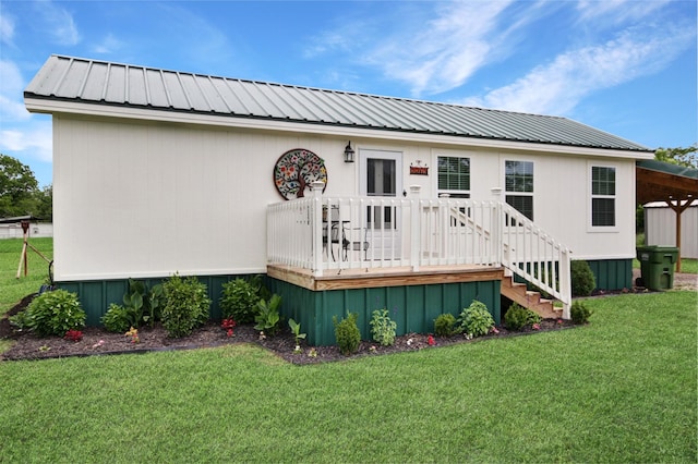 7265 Guadalupe Trl, Weatherford, TX 76087 - back of property featuring a lawn, a wooden deck, and metal roof