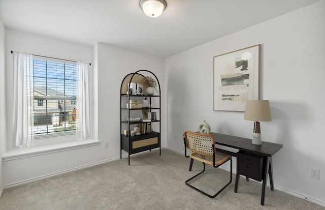 carpeted office space featuring baseboards