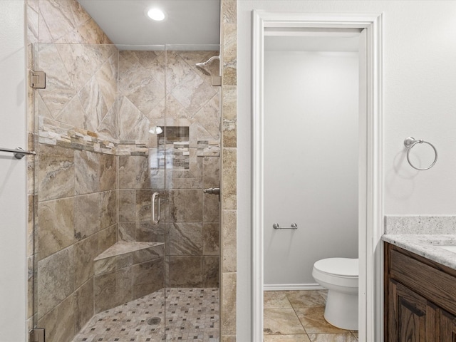 bathroom with a shower stall, toilet, vanity, and recessed lighting
