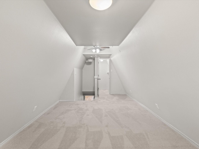 bonus room featuring ceiling fan, vaulted ceiling, carpet flooring, and baseboards