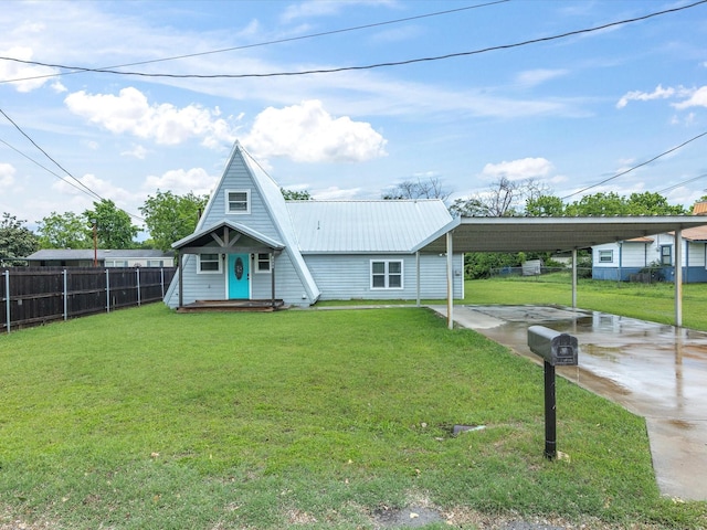 a-frame style home featuring a carport, metal roof, and driveway
