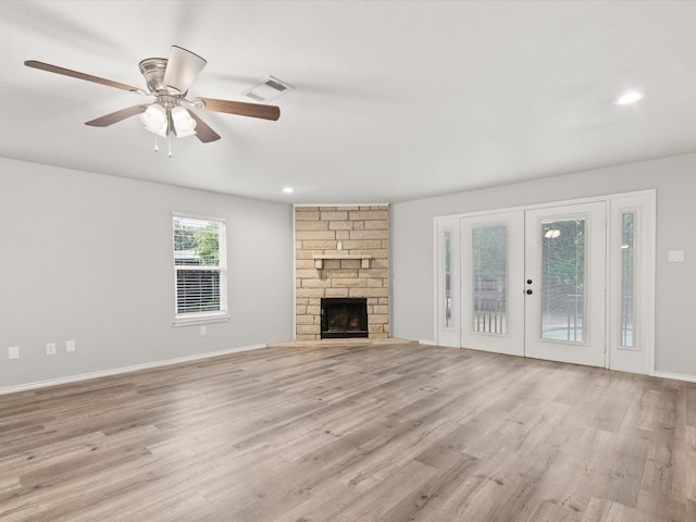unfurnished living room featuring light wood-style flooring, a fireplace, ceiling fan, recessed lighting, and baseboards