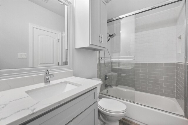 2730 Bryson Rd, Mansfield, TX 76063 - bathroom featuring toilet, vanity, and bath / shower combo with glass door