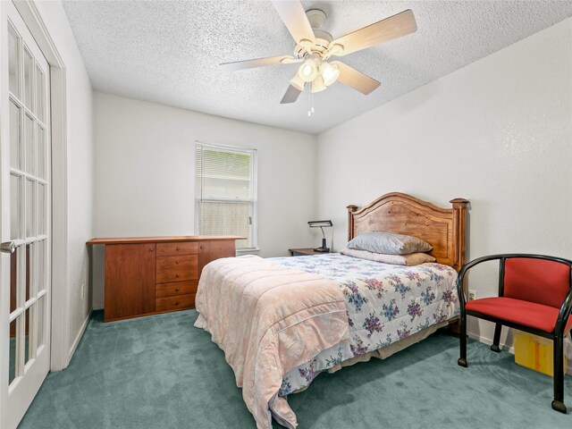 carpeted bedroom with a textured ceiling, ceiling fan, and baseboards