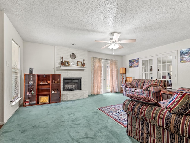 carpeted living room featuring ceiling fan, a brick fireplace, french doors, and a textured ceiling