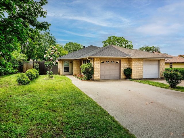 ranch-style house featuring an attached garage, concrete driveway, brick siding, and roof with shingles
