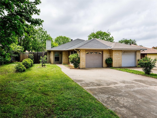 ranch-style home with an attached garage, brick siding, a chimney, and driveway