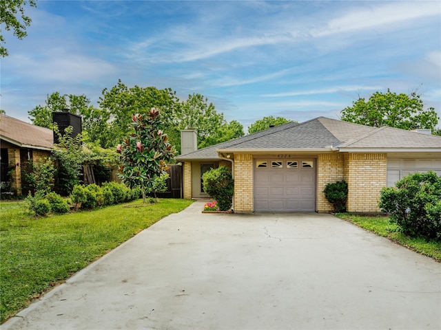 view of front of house with driveway, a garage, a front lawn, and brick siding
