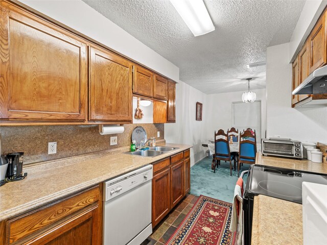 kitchen featuring dishwasher, a sink, electric range, light countertops, and brown cabinetry