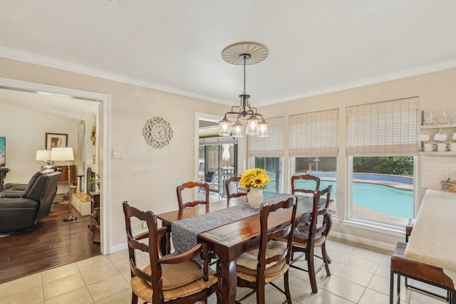 5008 Caliente Dr, Arlington, TX 76017 - dining area featuring crown molding, light tile patterned floors, healthy amount of natural light, a chandelier, and baseboards