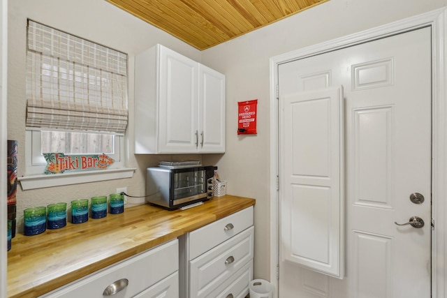 5008 Caliente Dr, Arlington, TX 76017 - kitchen featuring wooden counters, white cabinets, and wooden ceiling