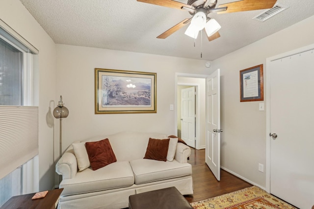 5008 Caliente Dr, Arlington, TX 76017 - living room featuring wood finished floors, a ceiling fan, and a textured ceiling