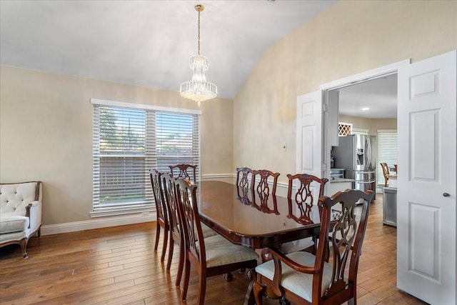2098 Amber Ct, Lewisville, TX 75067 - dining room with hardwood / wood-style floors, baseboards, a chandelier, and high vaulted ceiling