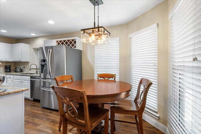 2098 Amber Ct, Lewisville, TX 75067 - dining area featuring dark wood finished floors, a chandelier, and recessed lighting