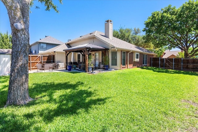 2098 Amber Ct, Lewisville, TX 75067 - rear view of property featuring a patio area, a chimney, a gazebo, and brick siding