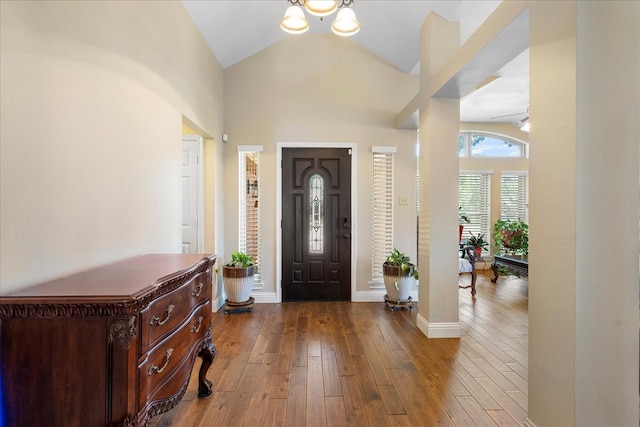 2098 Amber Ct, Lewisville, TX 75067 - foyer entrance featuring a chandelier, hardwood / wood-style flooring, high vaulted ceiling, and baseboards